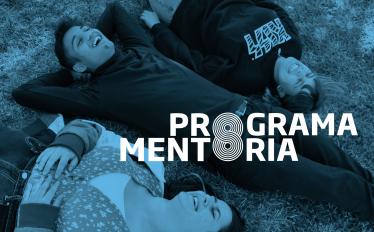 estudantes deitados na relva com menção do programa mentoria 